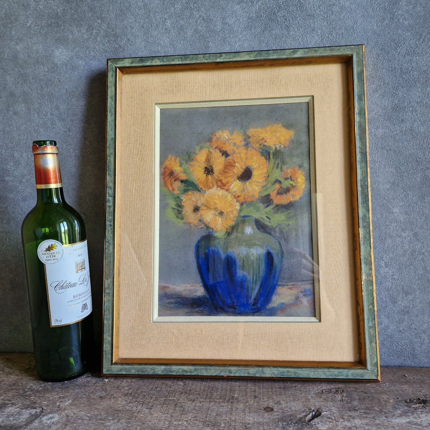 French pastel picture of sunflowers in a blue vase.
