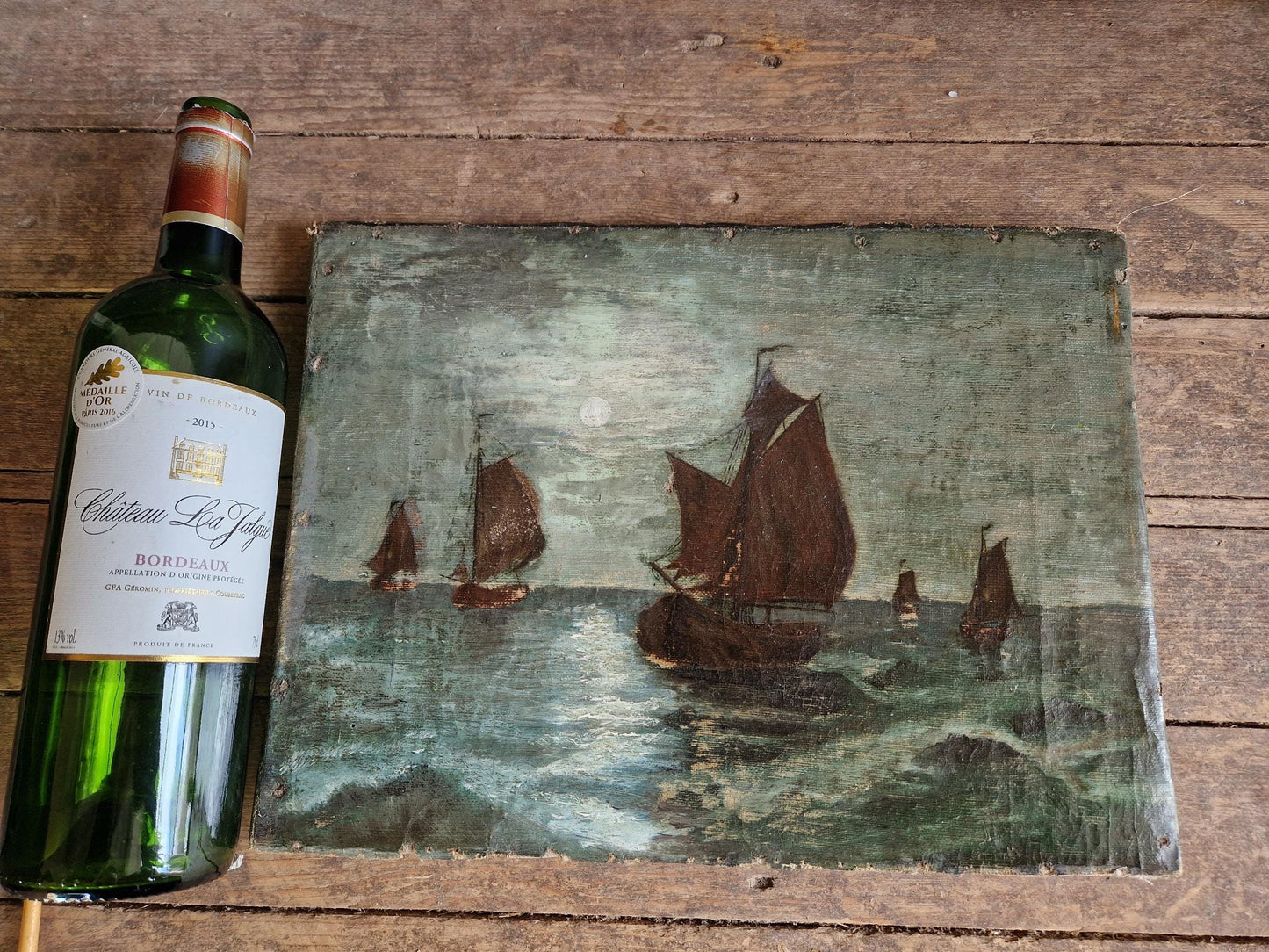 French antique seascape oil painting showing fishing boats on the sea in the moonlight.