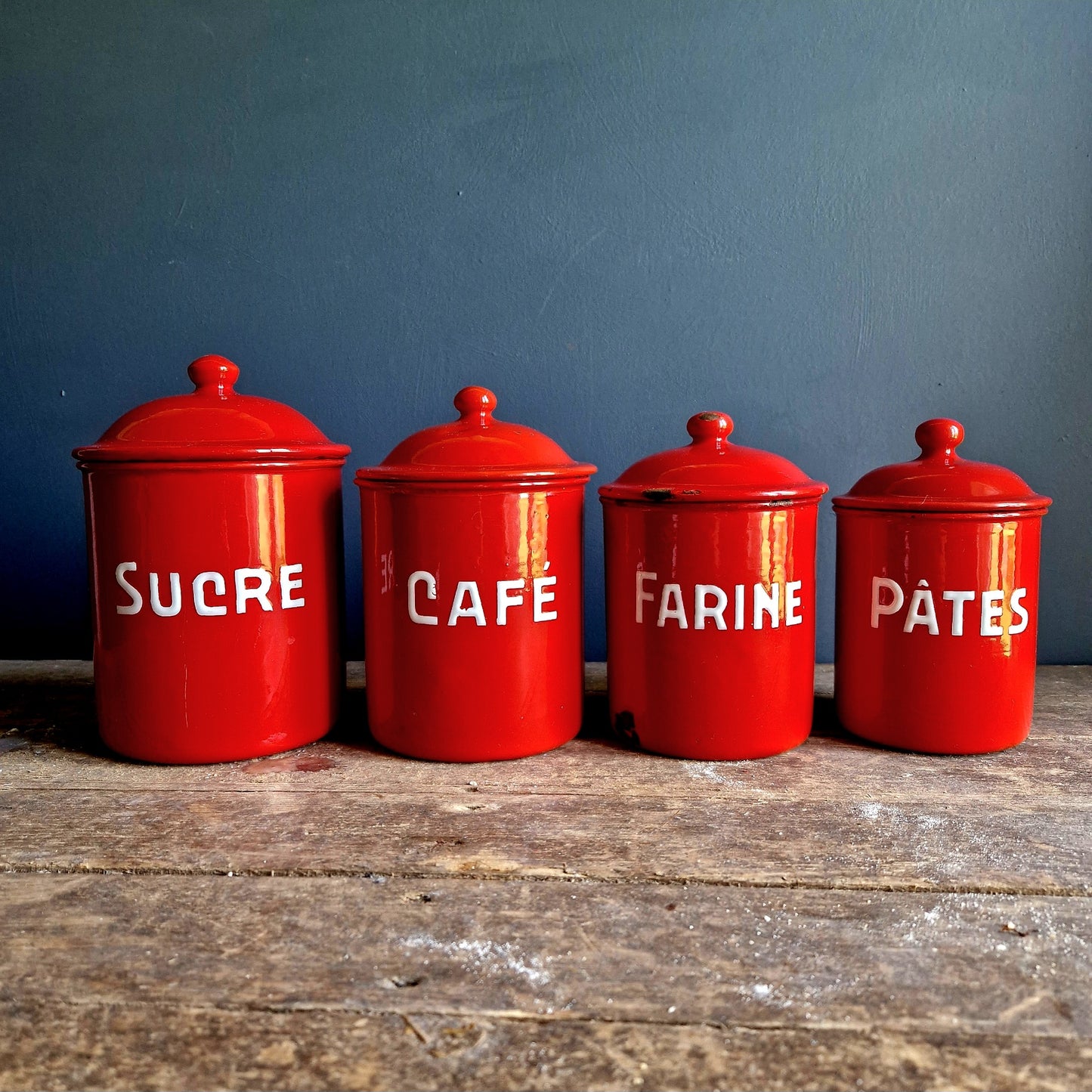 Set of Four graduated French vintage red kitchen canisters.