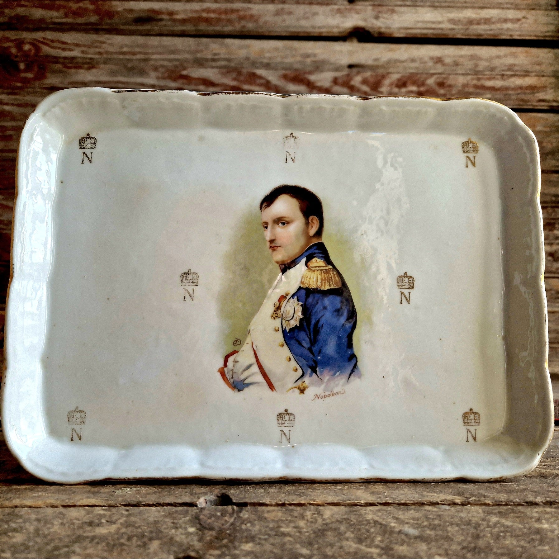 White porcelain Napoleon dish on wooden table top.