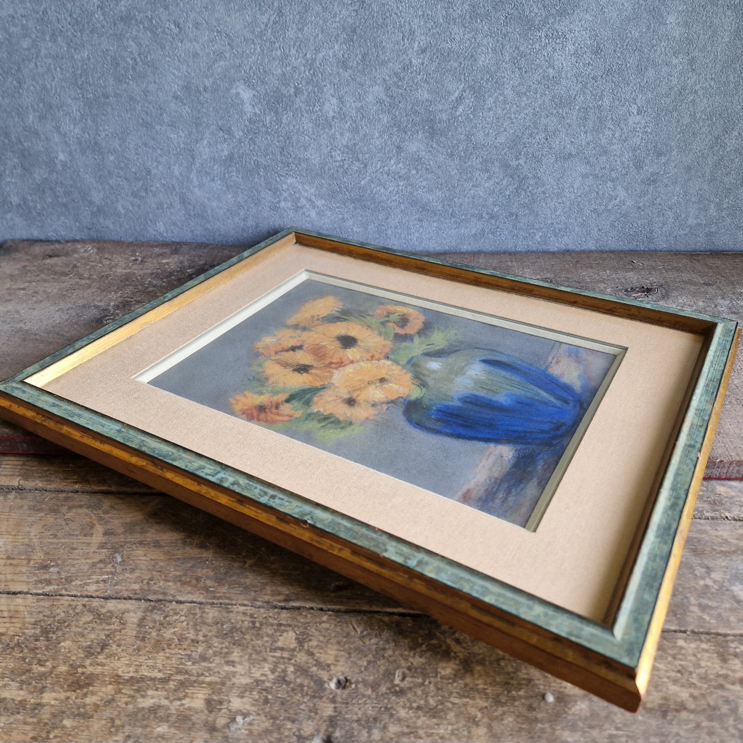 French pastel picture of sunflowers in a blue vase.