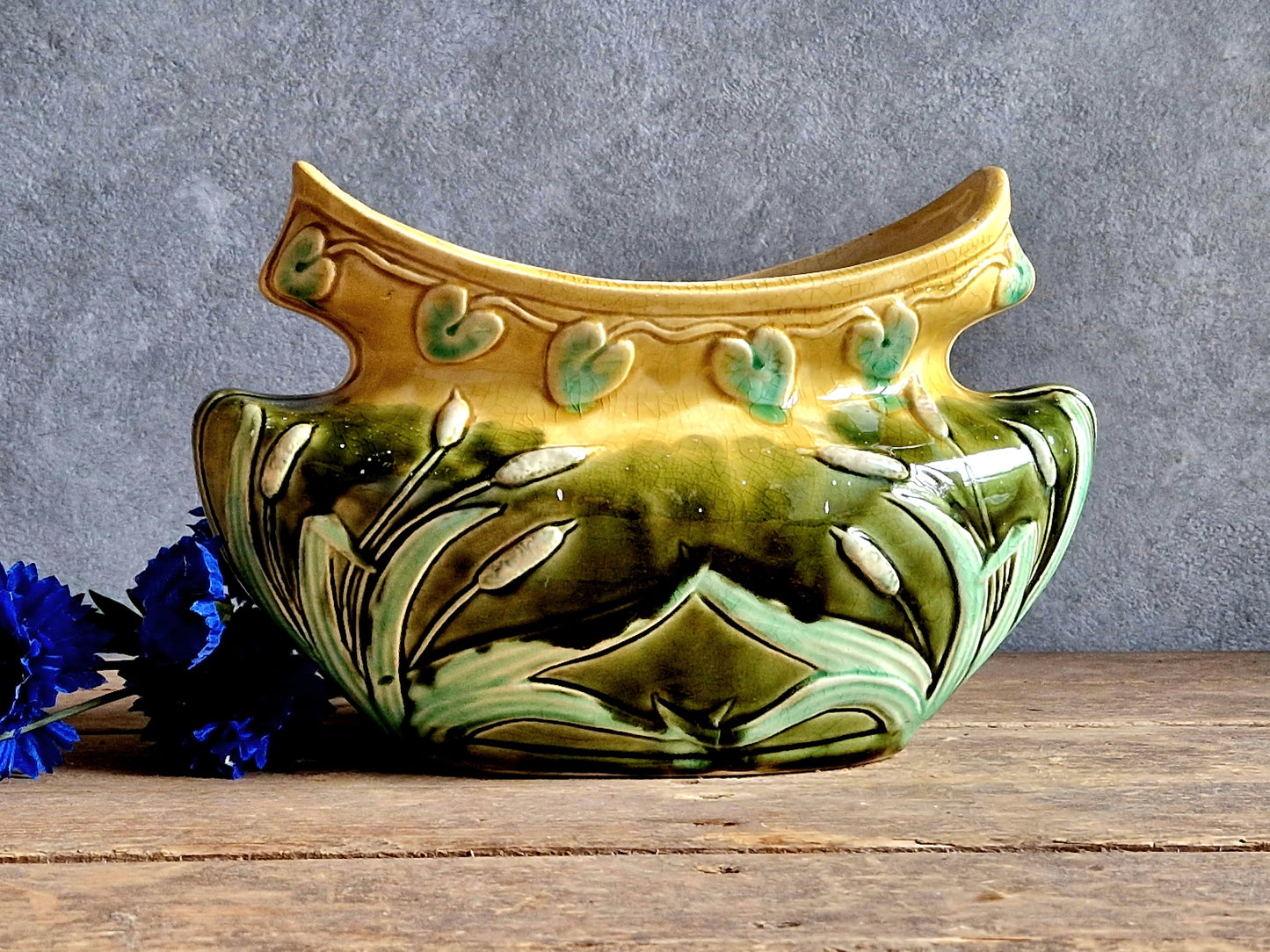 Decorative ceramic planter with floral design on a wooden surface