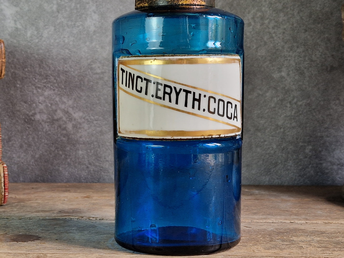 French blue antique apothecary bottle with toleware lid.
