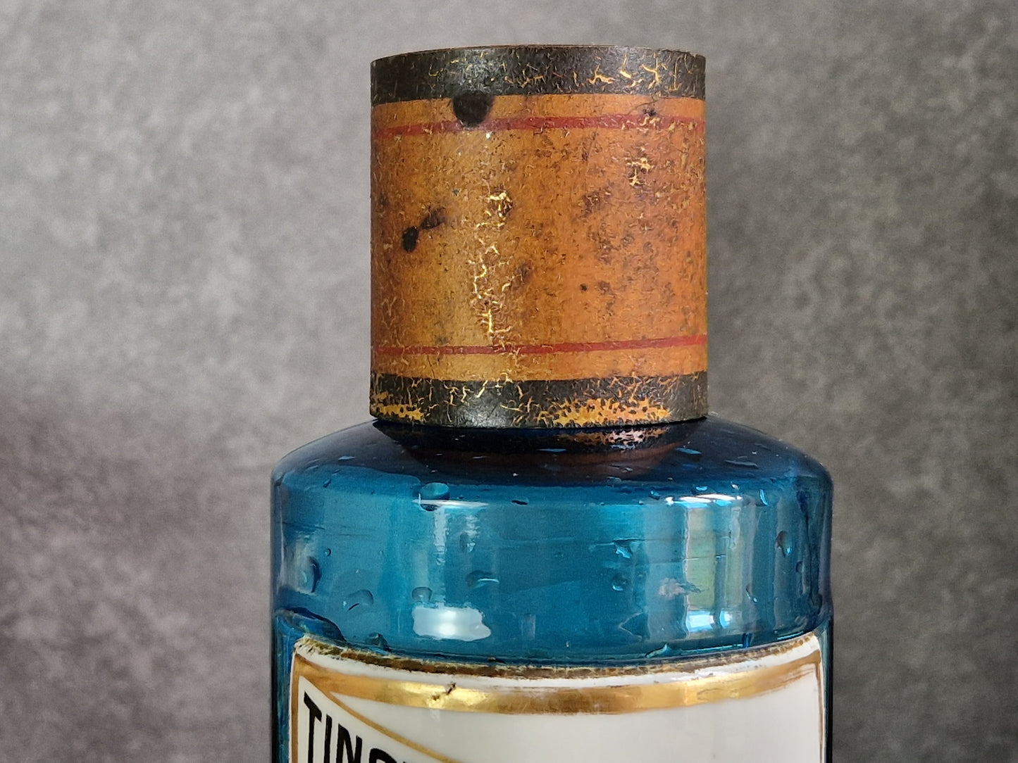 French blue antique apothecary bottle with toleware lid.