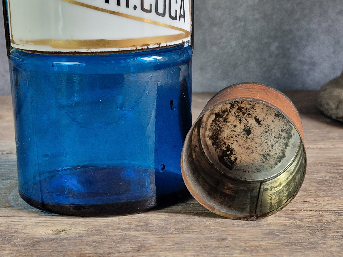 French blue antique apothecary bottle with toleware lid.