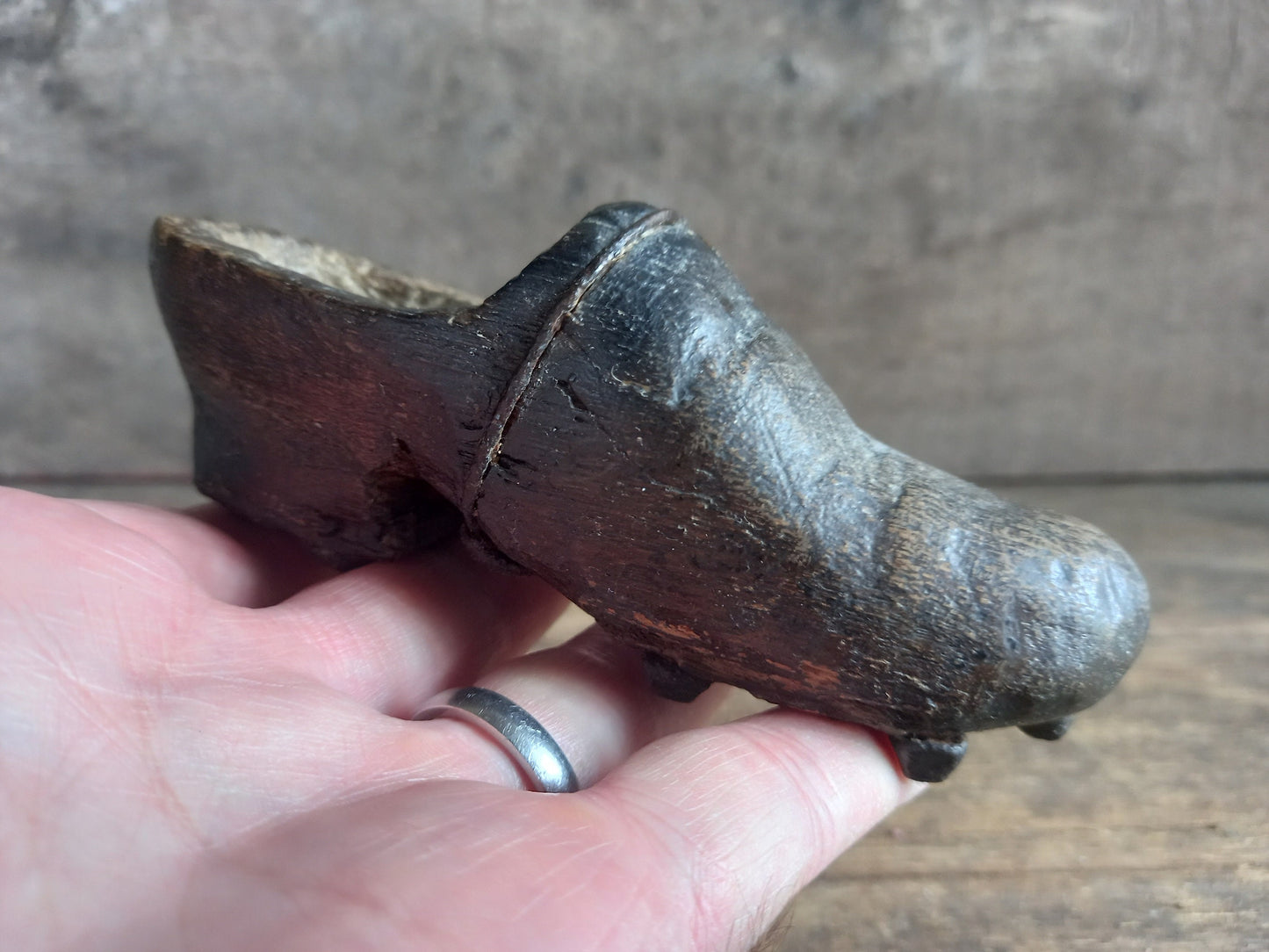 Antique miniature shoe. Antique wooden shoe with metal studs.