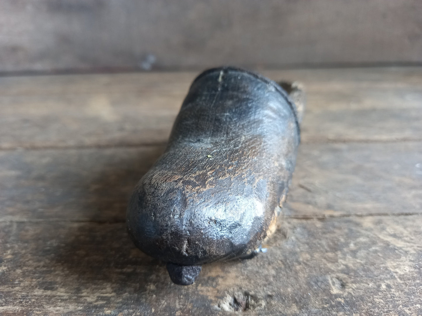 Antique miniature shoe. Antique wooden shoe with metal studs.