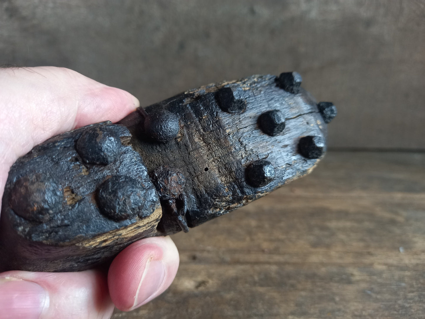 Antique miniature shoe. Antique wooden shoe with metal studs.