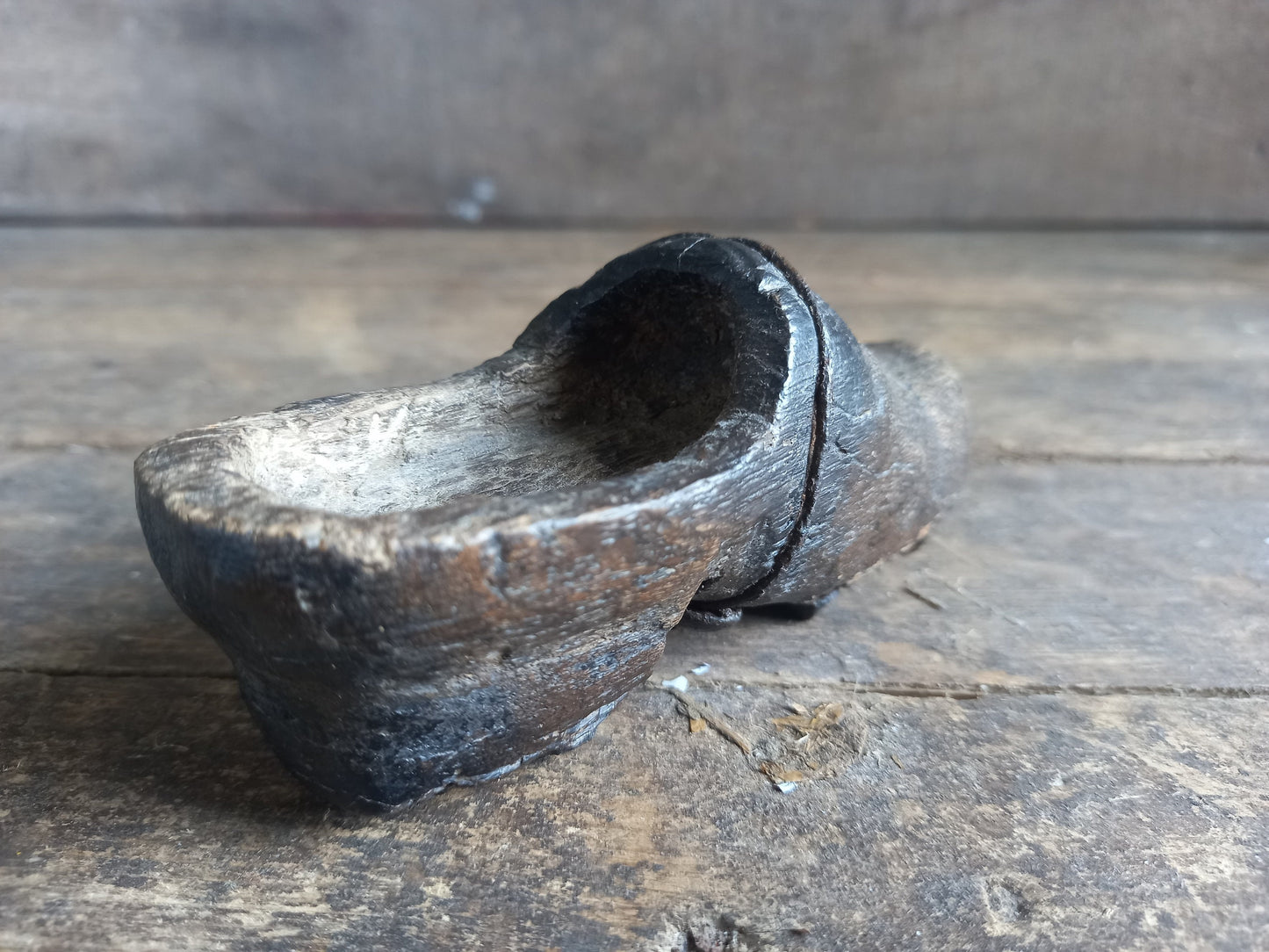 Antique miniature shoe. Antique wooden shoe with metal studs.