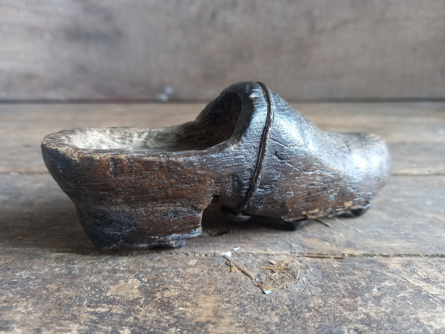 Antique miniature shoe. Antique wooden shoe with metal studs.