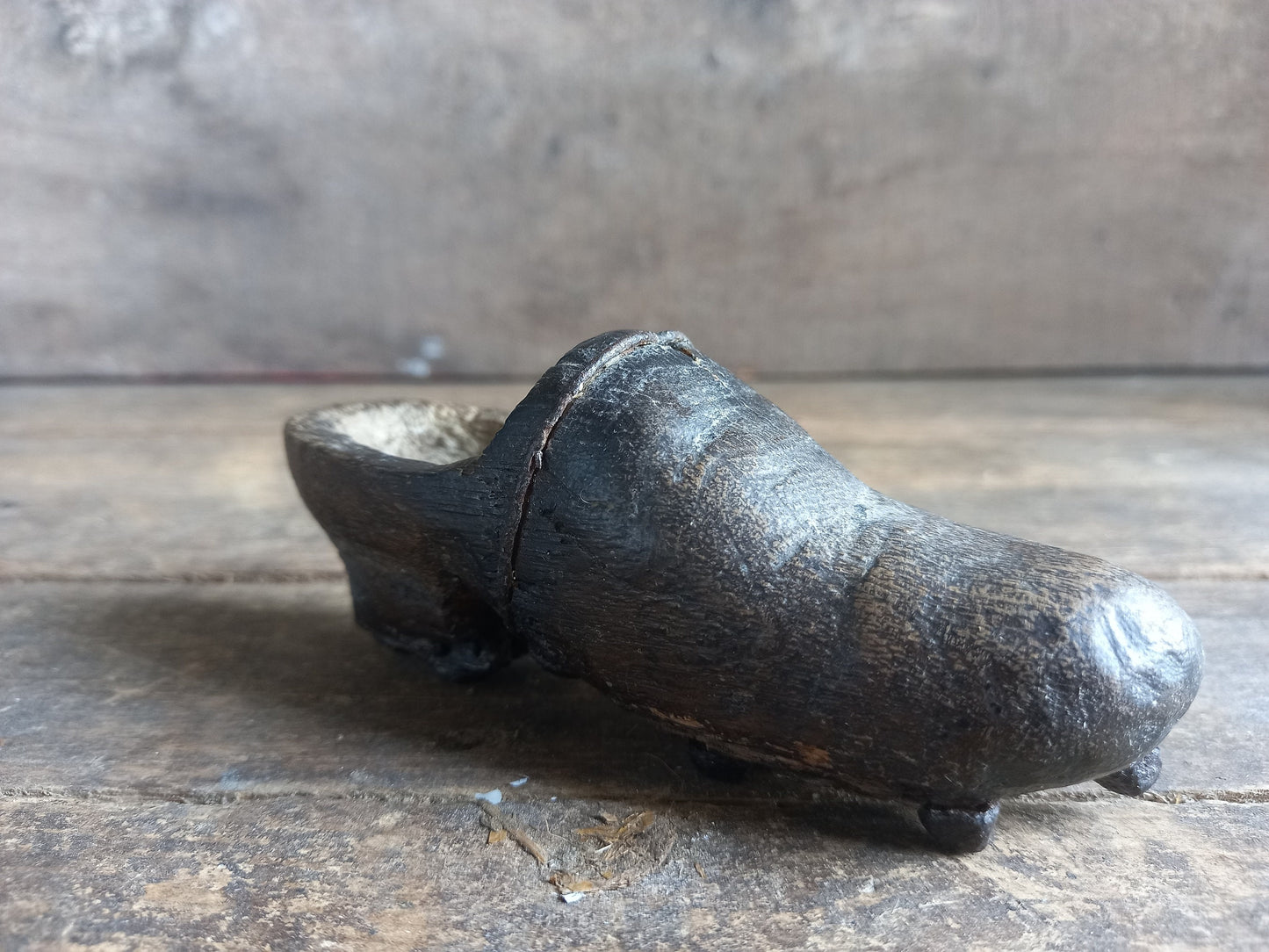 Antique miniature shoe. Antique wooden shoe with metal studs.
