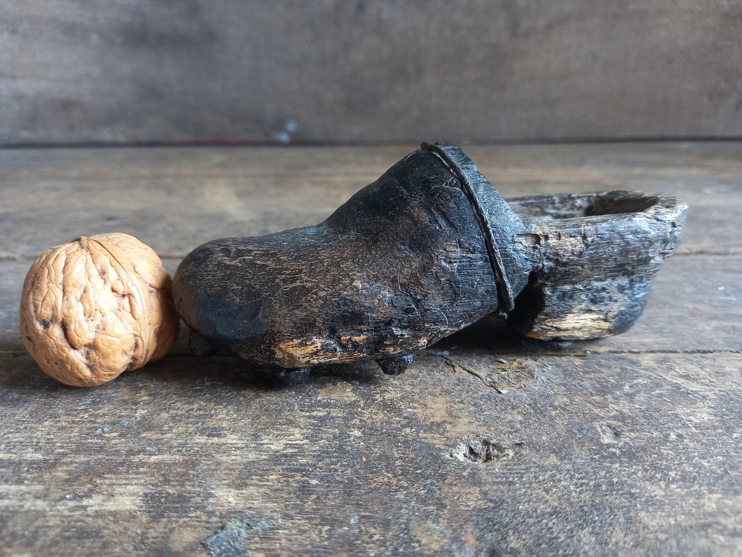 Antique miniature shoe. Antique wooden shoe with metal studs.