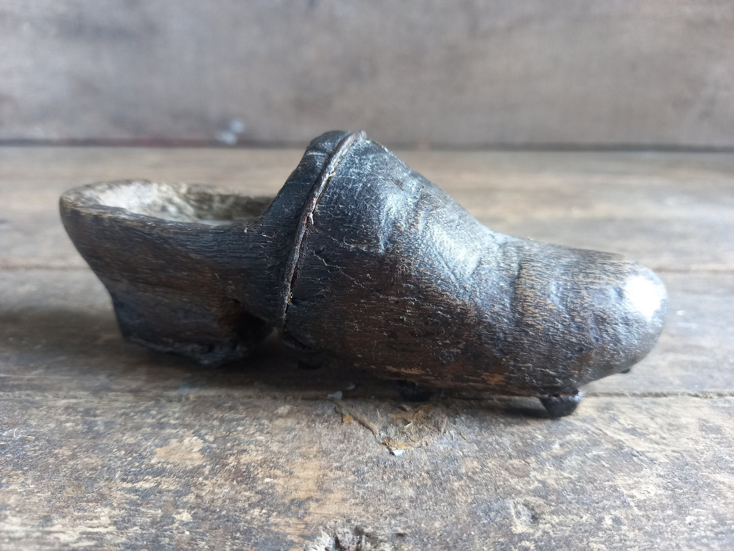 Antique miniature shoe. Antique wooden shoe with metal studs.