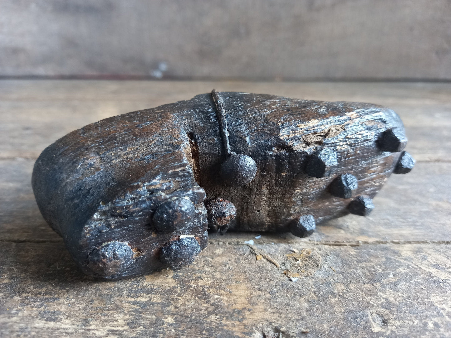 Antique miniature shoe. Antique wooden shoe with metal studs.