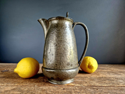 antique pewter jug with lemons.