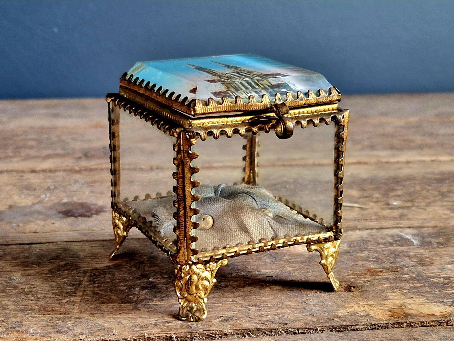 Antique French glass jewelry box with blue silk lining.
