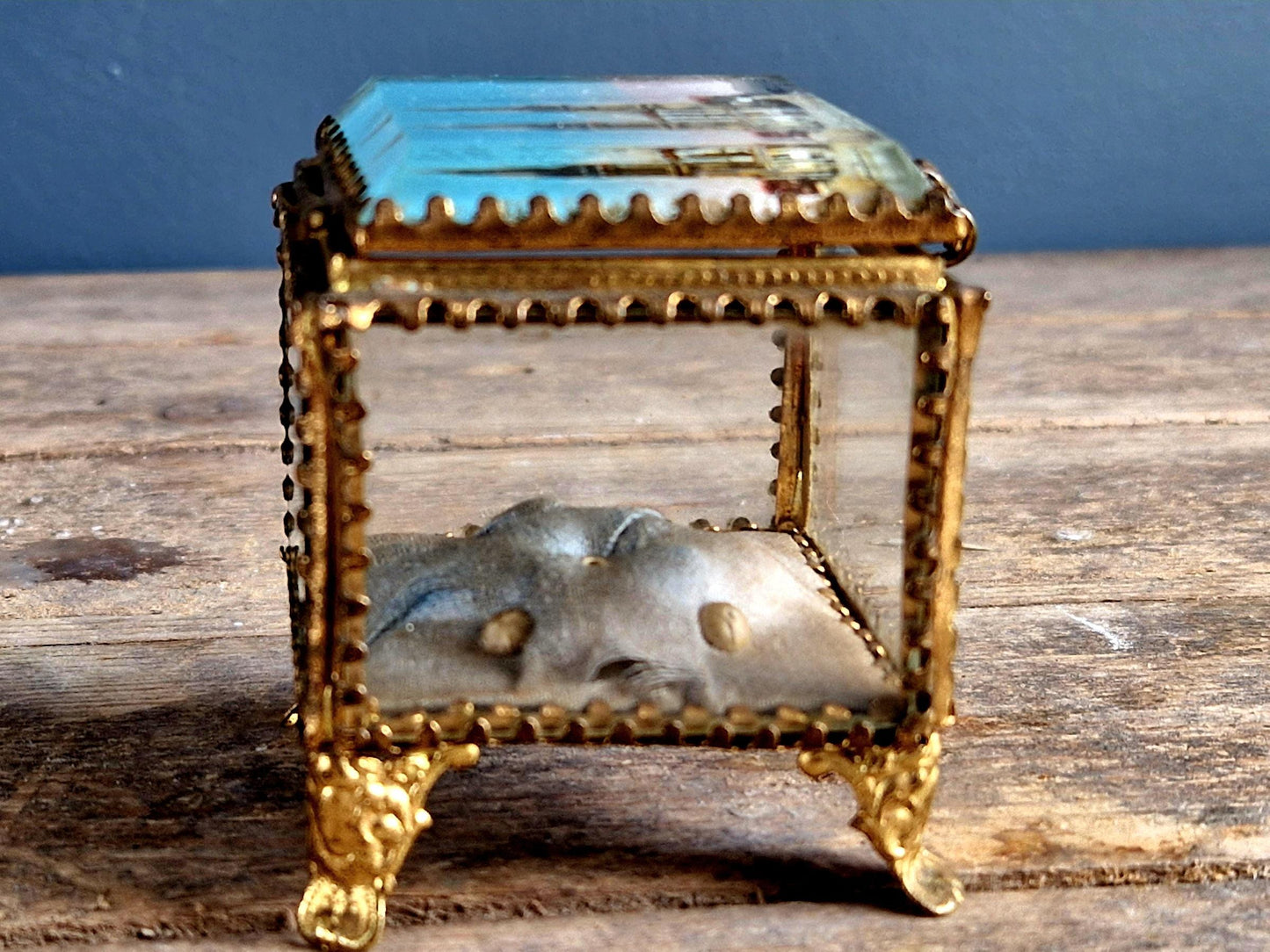 Antique French glass jewelry box with blue silk lining.