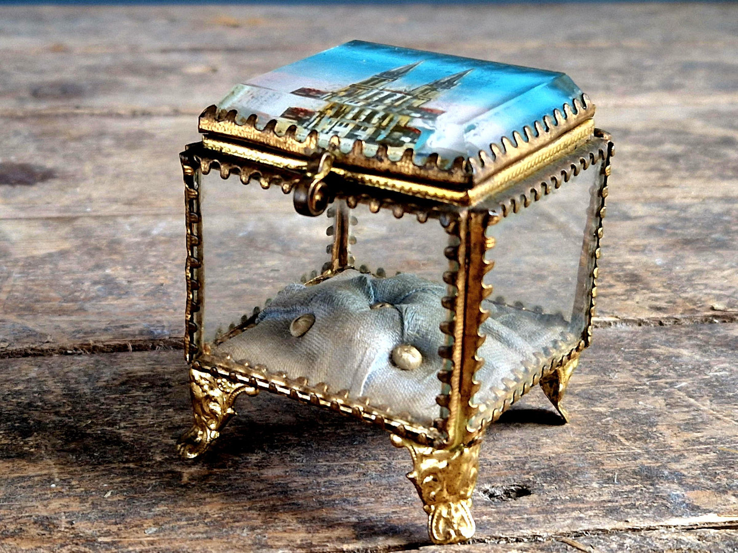Antique French glass jewelry box with blue silk lining.