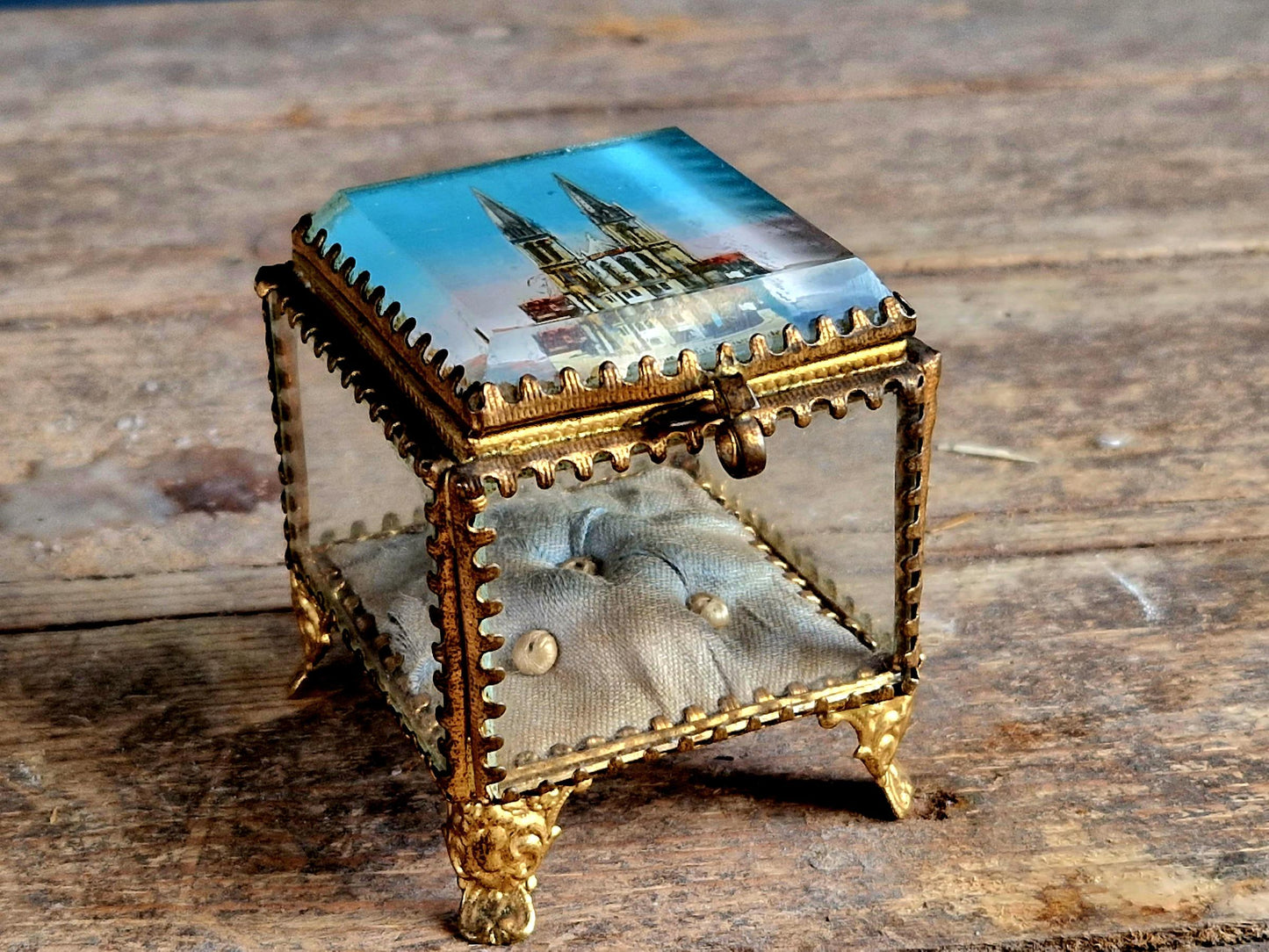 Antique French glass jewelry box with blue silk lining.