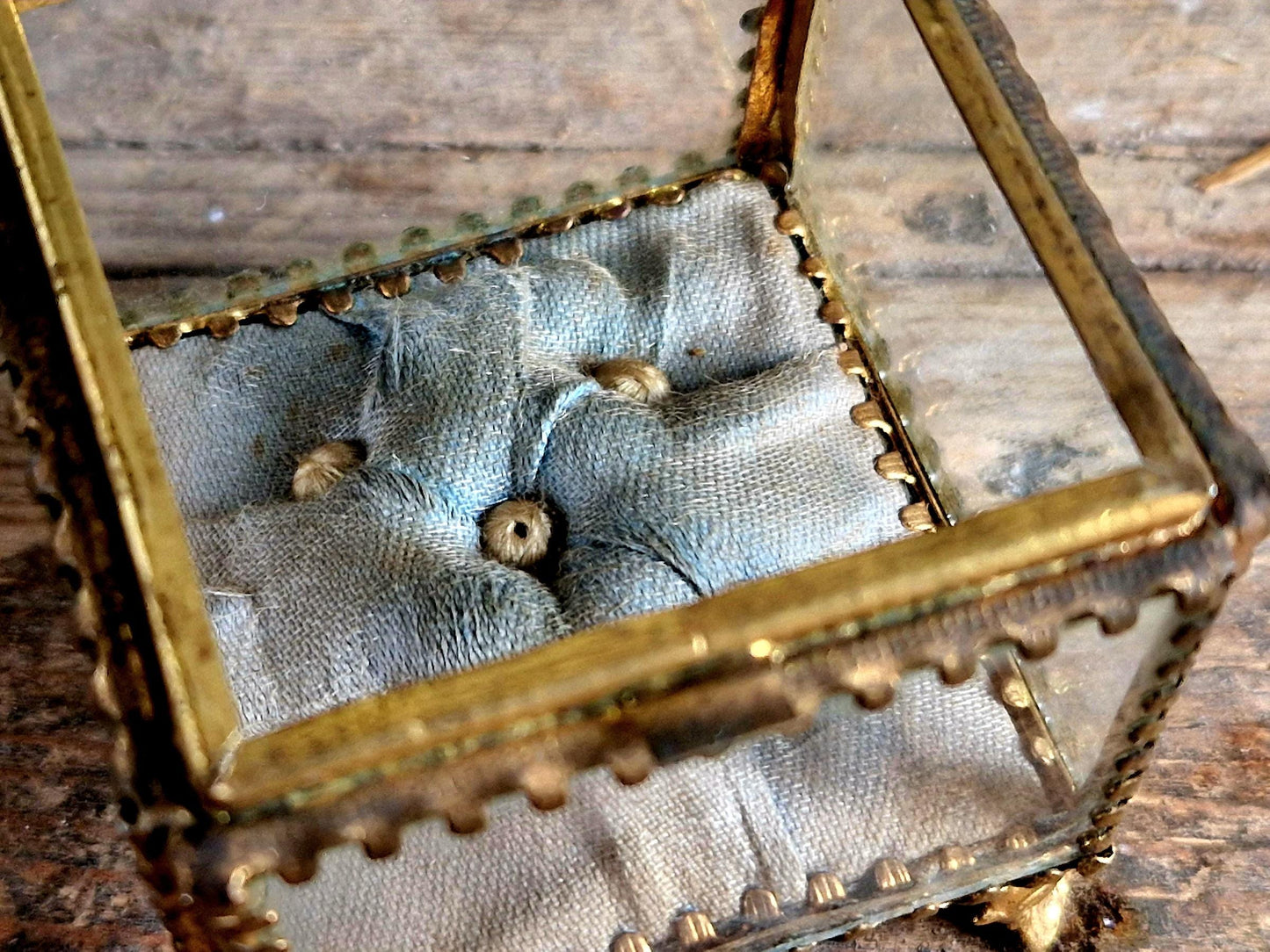 Antique French glass jewelry box with blue silk lining.
