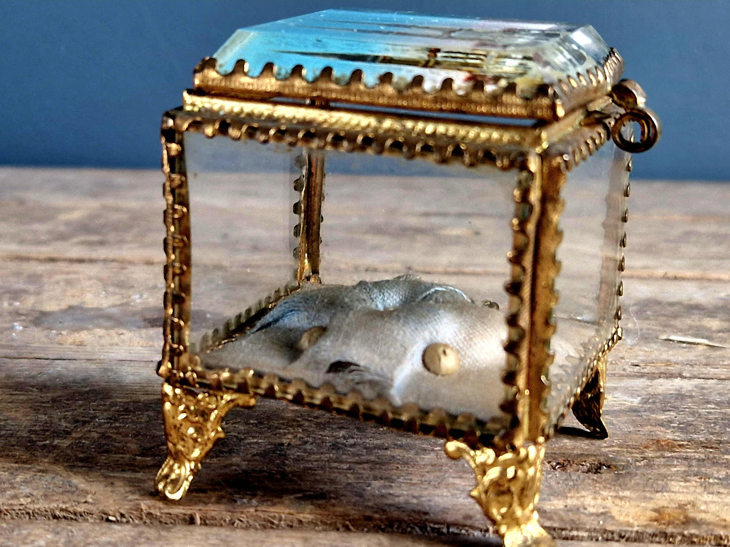 Antique French glass jewelry box with blue silk lining.