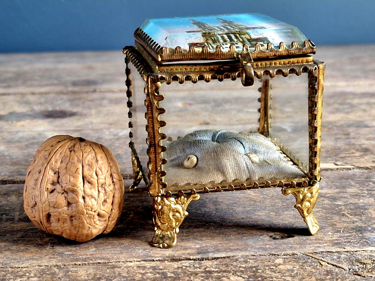 Antique French glass jewelry box with blue silk lining.