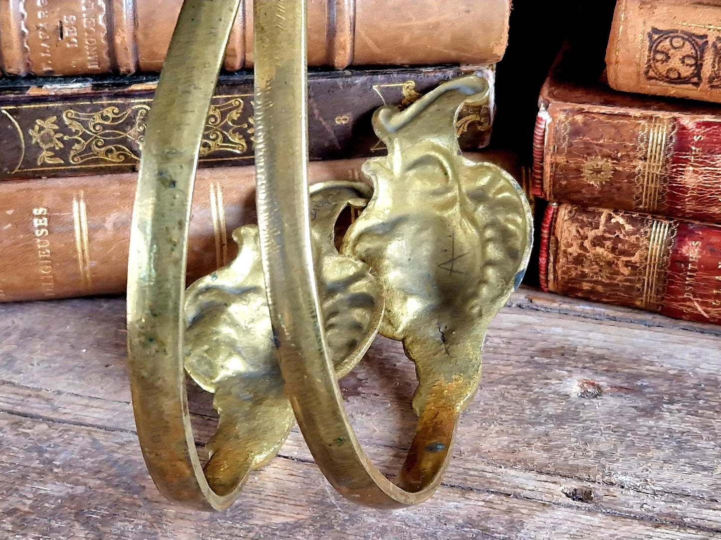 French gilt brass curtain tiebacks. Pair of French rococo style gilt brass tiebacks.