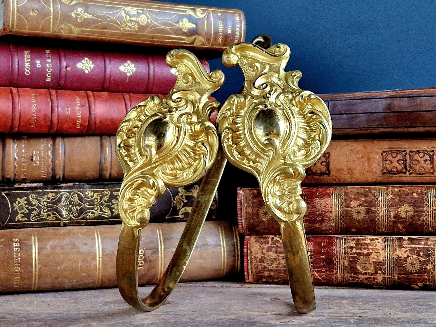 French gilt brass curtain tiebacks. Pair of French rococo style gilt brass tiebacks.