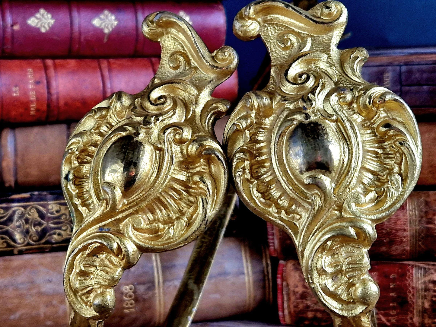 French gilt brass curtain tiebacks. Pair of French rococo style gilt brass tiebacks.
