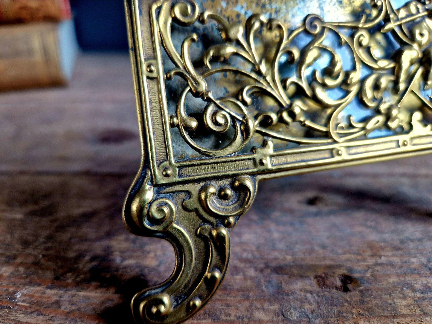 French antique glass photo frame with gilt scrolling metal base.