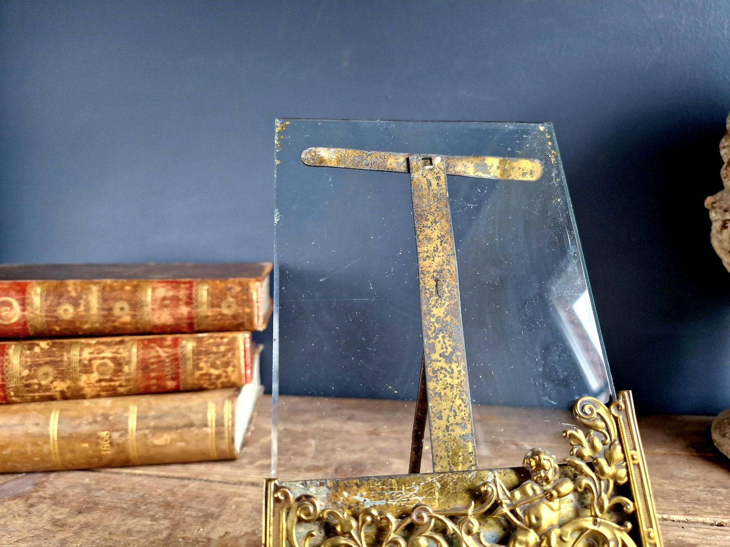 French antique glass photo frame with gilt scrolling metal base.