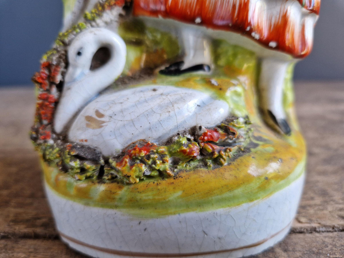 Antique Staffordshire flatback statue of a girl with a swan.