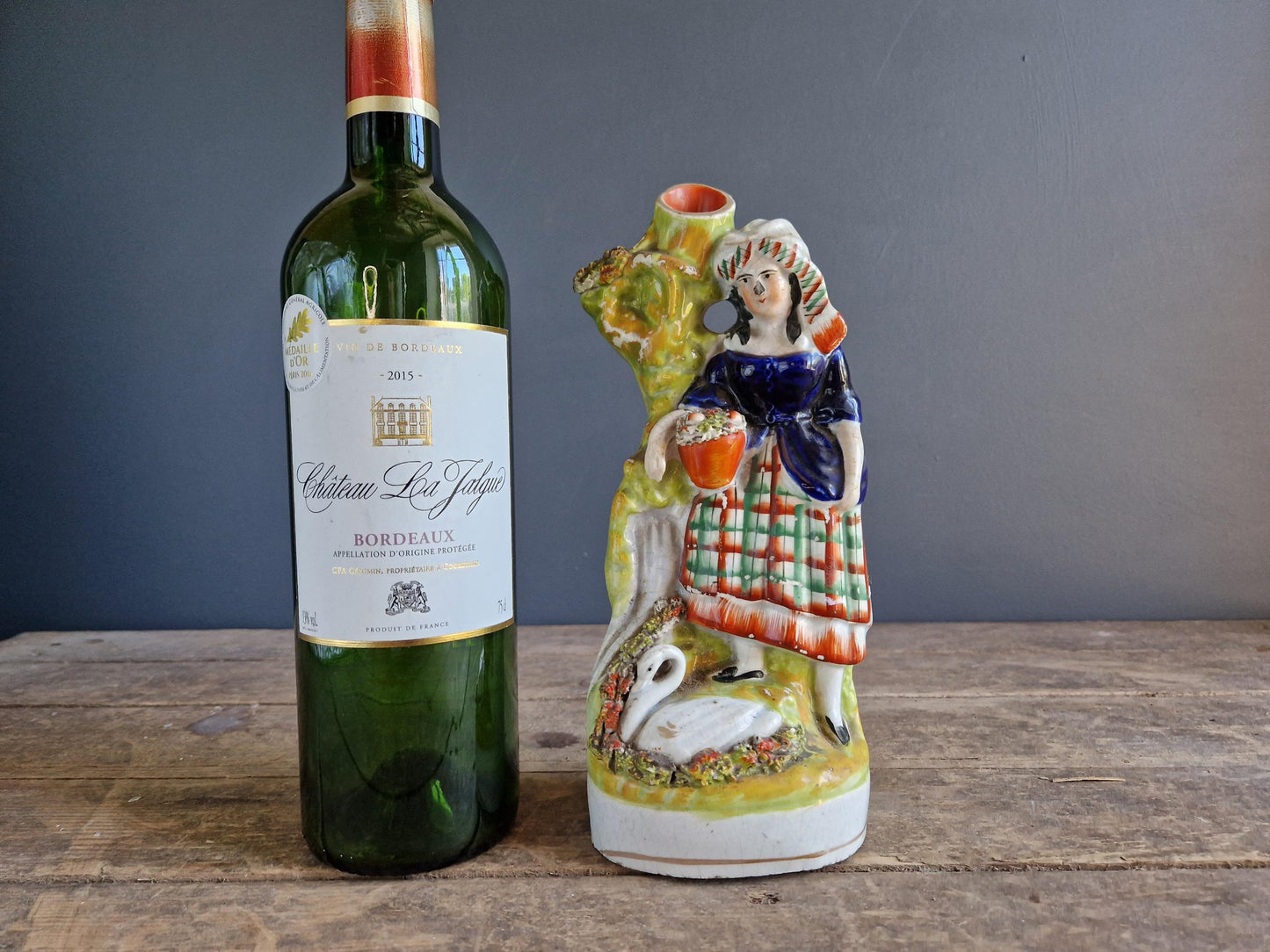 Antique Staffordshire flatback statue of a girl with a swan.