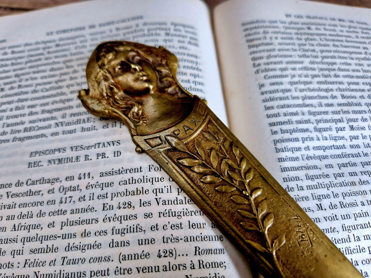 French bronze Art Nouveau paper knife with ladies head decoration.